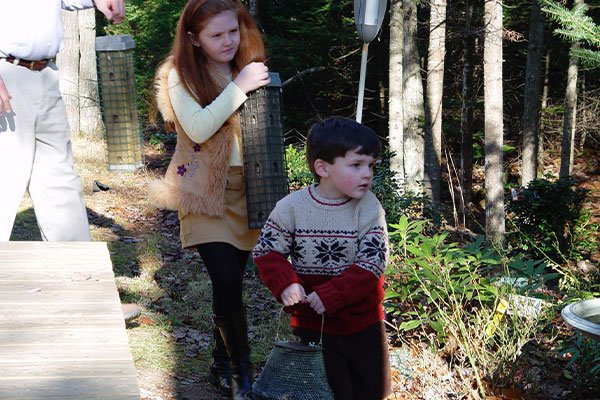 Kids filling bird feeders