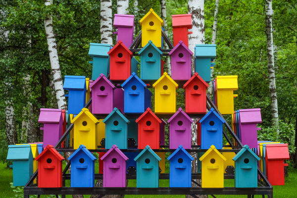 colorful birdhouses stacked in a pyramid shape